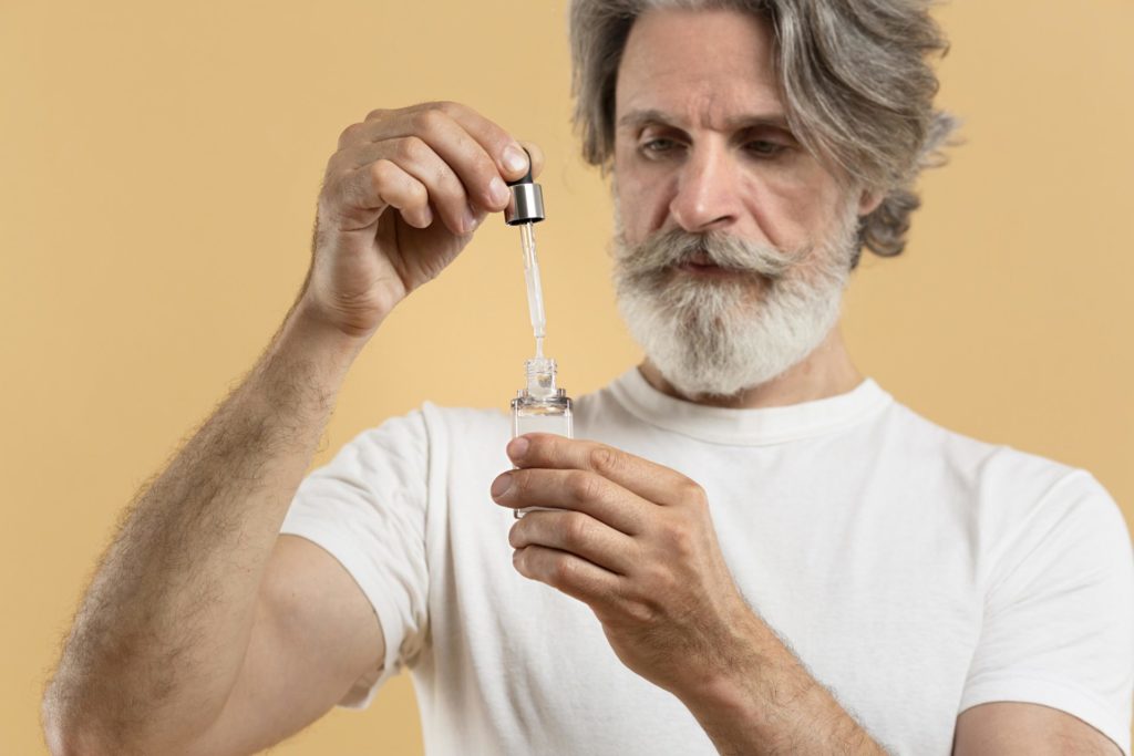 front-view-bearded-senior-man-holding-serum