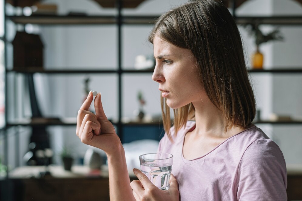 side-view-sick-young-woman-looking-pill
