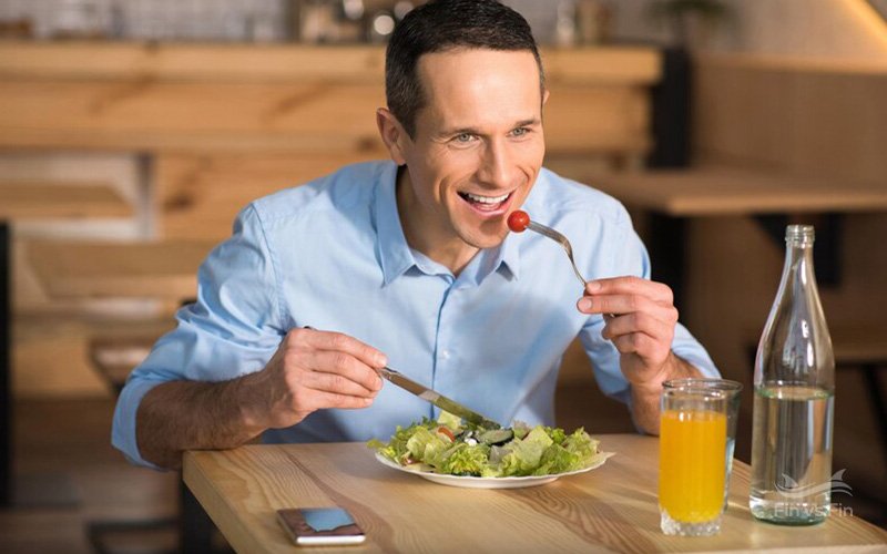 happy businessman eating salad